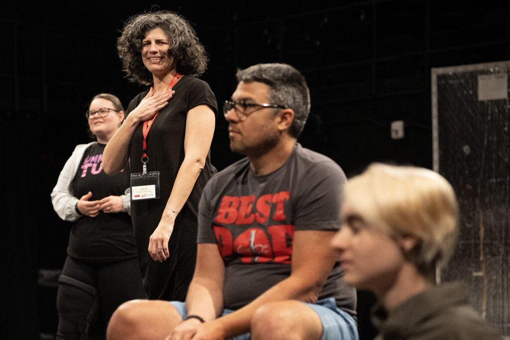 a faculty member looks admiringly at students.