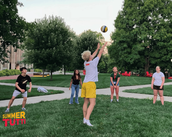 Students playing with a volleyball