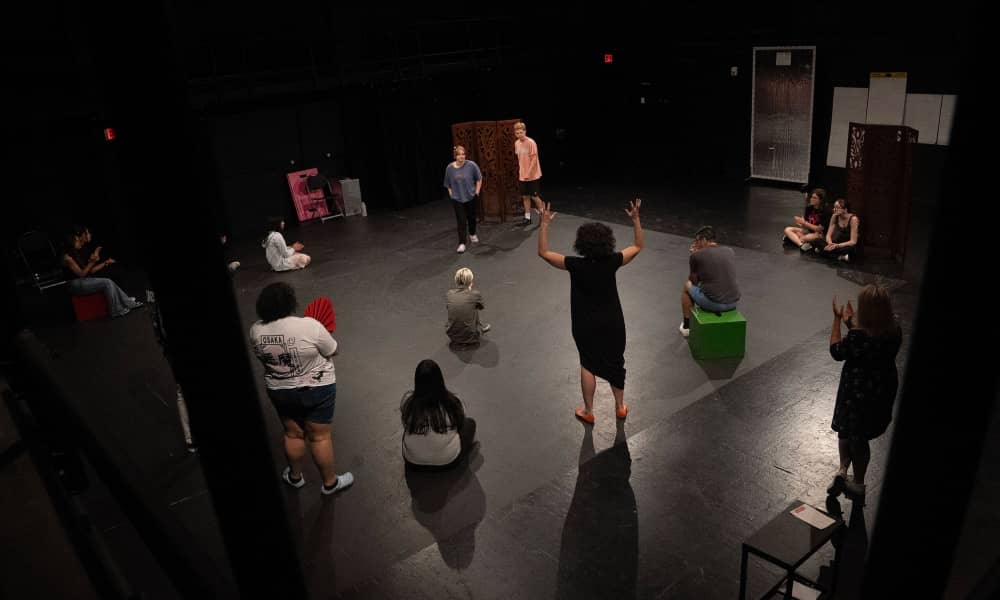 A group of students and teachers gathered in a circle